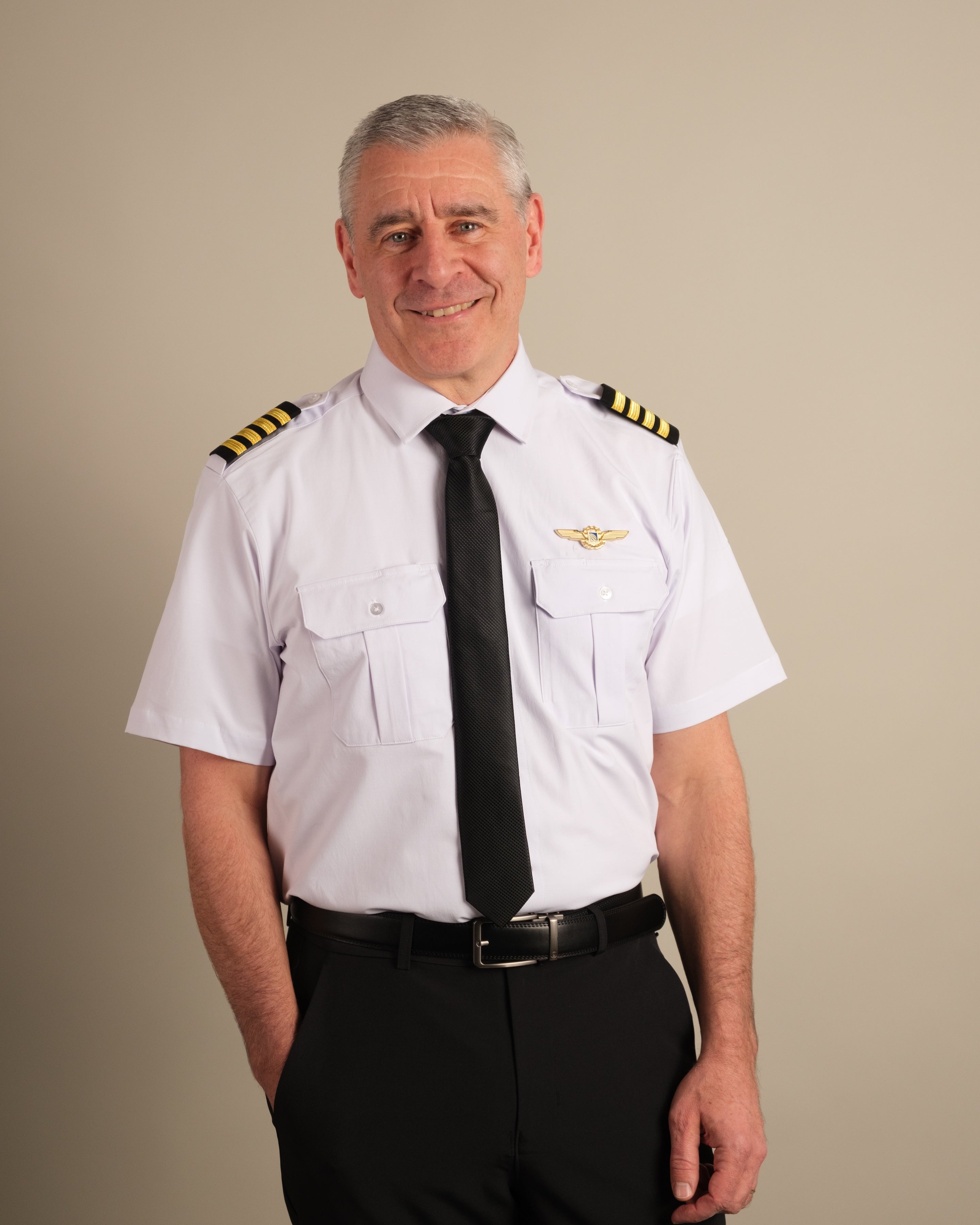 Airline captain wearing white Cloud Cotton pilot uniform with four-stripe gold epaulettes and wings