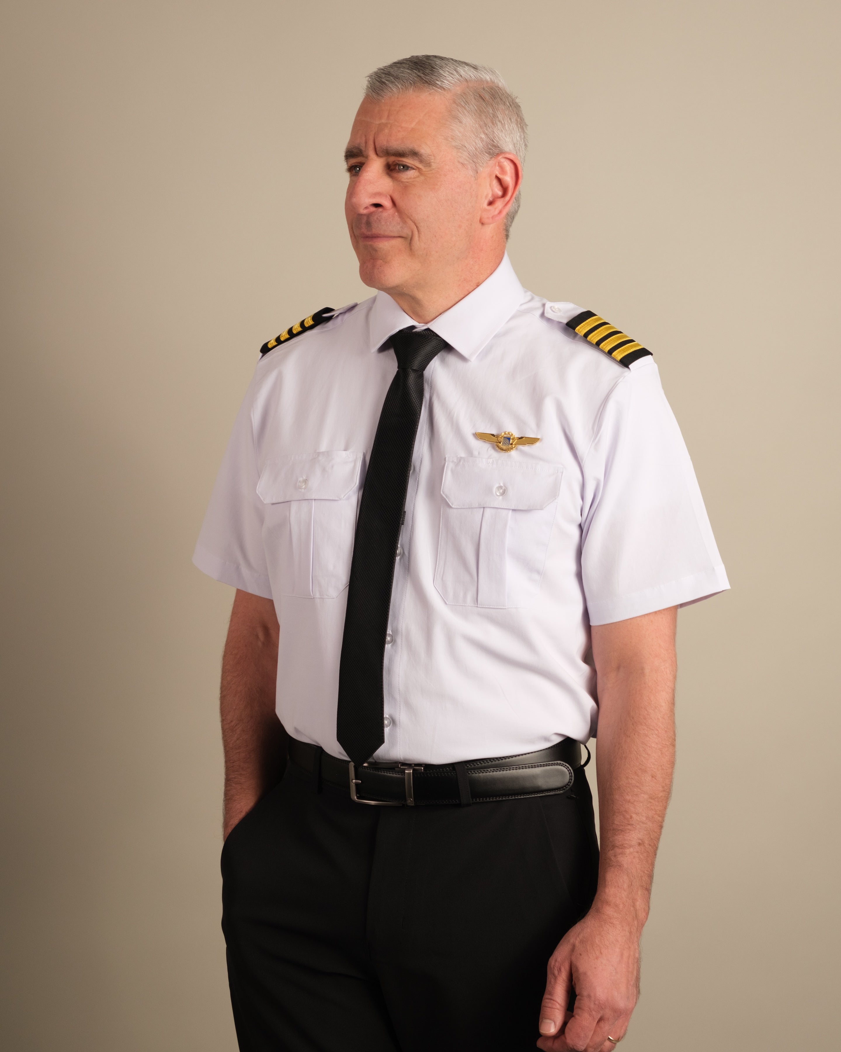 Full-length portrait of airline captain in white Cloud Cotton pilot uniform